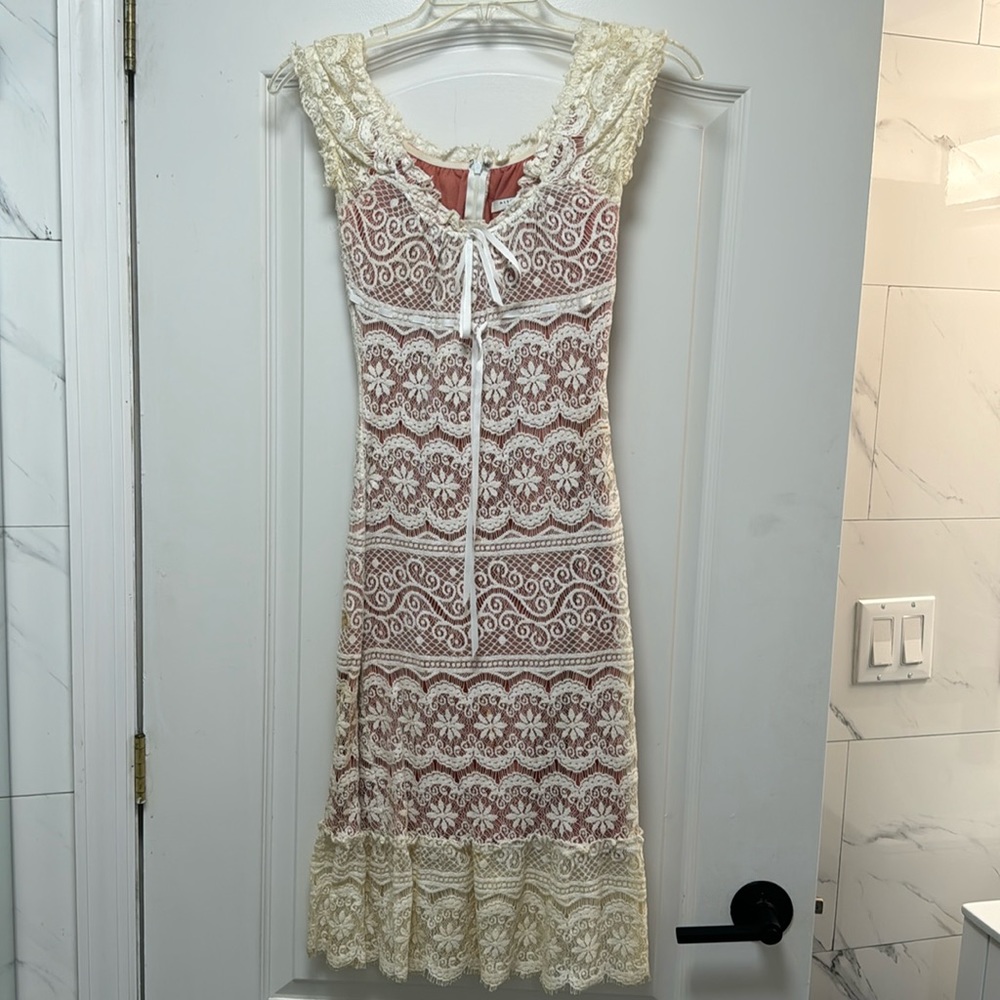 Lace off white dress with pink lining.
